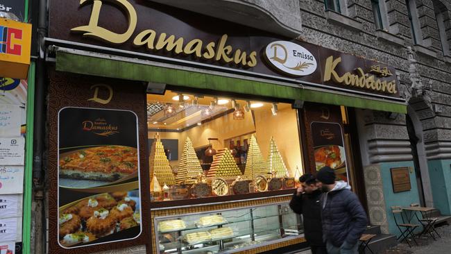 People walk past a Syrian pastry shop in immigrant-heavy Neukoelln district, in Berlin. Picture: Getty Images