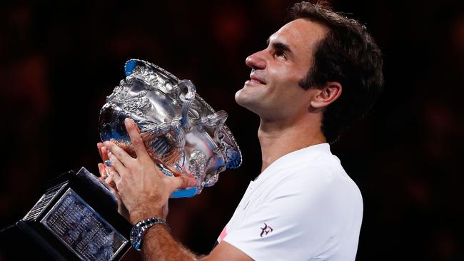 Roger Federer holds the Australian Open trophy aloft after defeating Marin Cilic in Melbourne last night. Picture: Getty Images