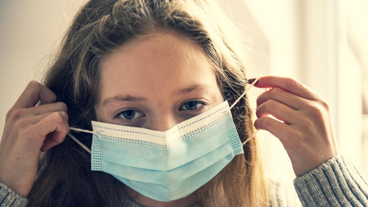 Portrait close up of girl wearing protective mask during pandemic