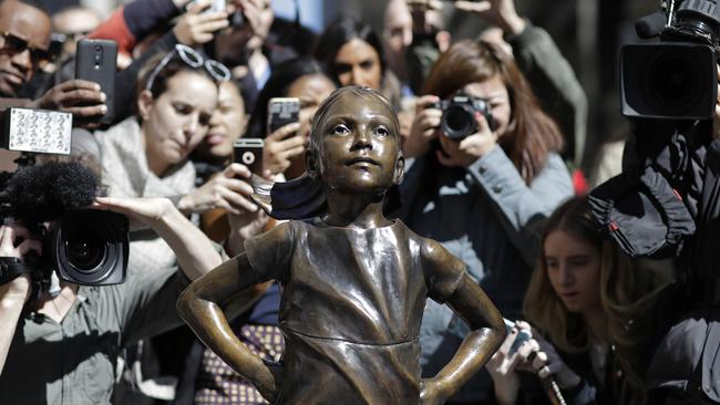 People stop to photograph the statue. Picture: Mark Lennihan/AP