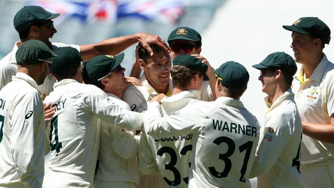 Scott Boland is mobbed after claiming the wicket of Ollie Robinson Picture: AFP