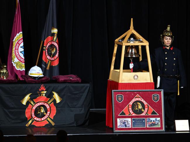 The Queensland firefighters bell and helmet during a memorial service for fallen Queensland Fire and Rescue Service firefighter Izabella “Izzy” Nash, held in Brisbane on Monday. Picture: Lyndon Mechielsen