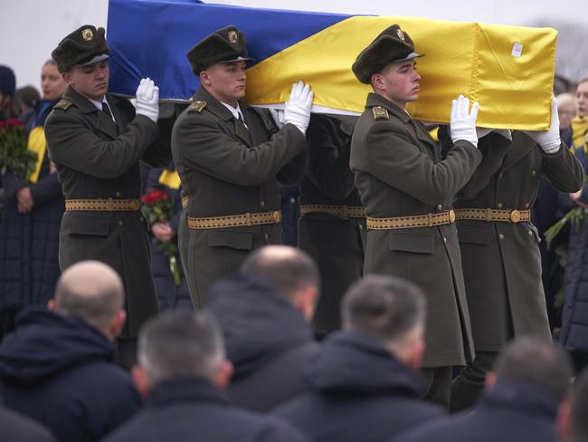 An honour guard carries a coffin of the one of the eleven Ukrainian victims of the shotdown plane. Picture: AP