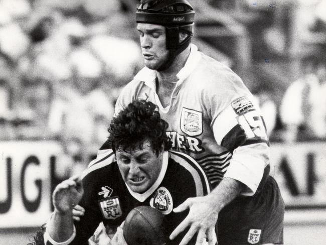 Chris Close is tackled by Greg Conescu as Keith Gee goes over the top at Seagulls Stadium. headshot sport rugby league.