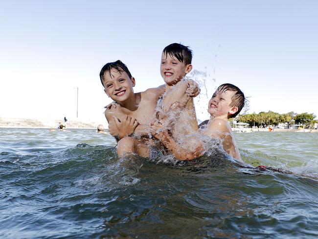 Azayah Palmer, 9, Alijah Palmer, 8, and Jayden Palmer, 10, pictured at the Wynnum wading pool, Brisbane. (Image/Josh Woning)