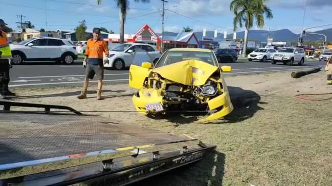 Car smashes light pole out of ground