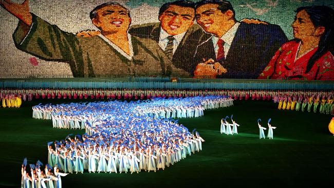 In honour of the state … performers create the shape of the Korean peninsula, during the Mass Games in 2007 Picture: AP