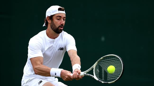 LONDON, ENGLAND - JULY 01: Jordan Thompson of Australia plays a backhand against Pavel Kotov in the in the Gentlemen's Singles first round match during day one of The Championships Wimbledon 2024 at All England Lawn Tennis and Croquet Club on July 01, 2024 in London, England. (Photo by Julian Finney/Getty Images)