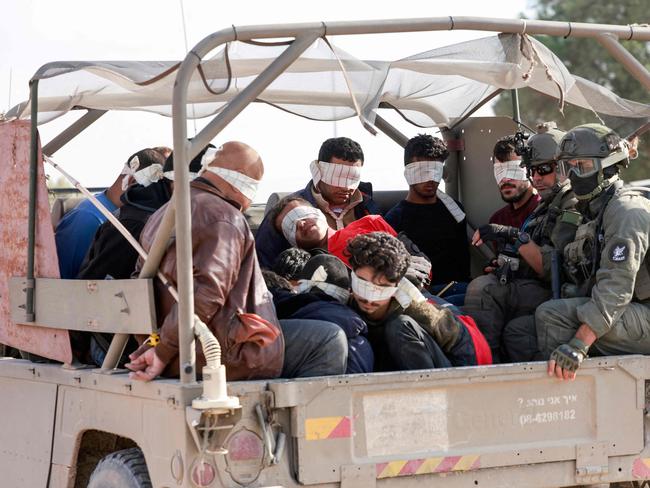 Israeli soldiers transfer detained Palestinians out of the Gaza Strip. Picture: AFP