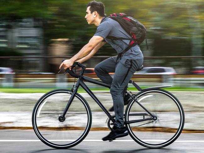 Young man cycling in the city, commuting to work in Chicago - USA.