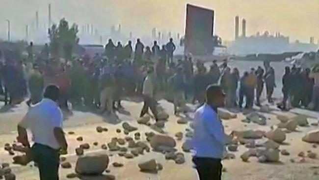 Workers block the road to the Asalouyeh energy plant. Picture: AFP