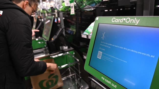 Shoppers at a Sydney supermarket, who were unable to use tap-and-go payment options when paying for groceries. Picture: AFP