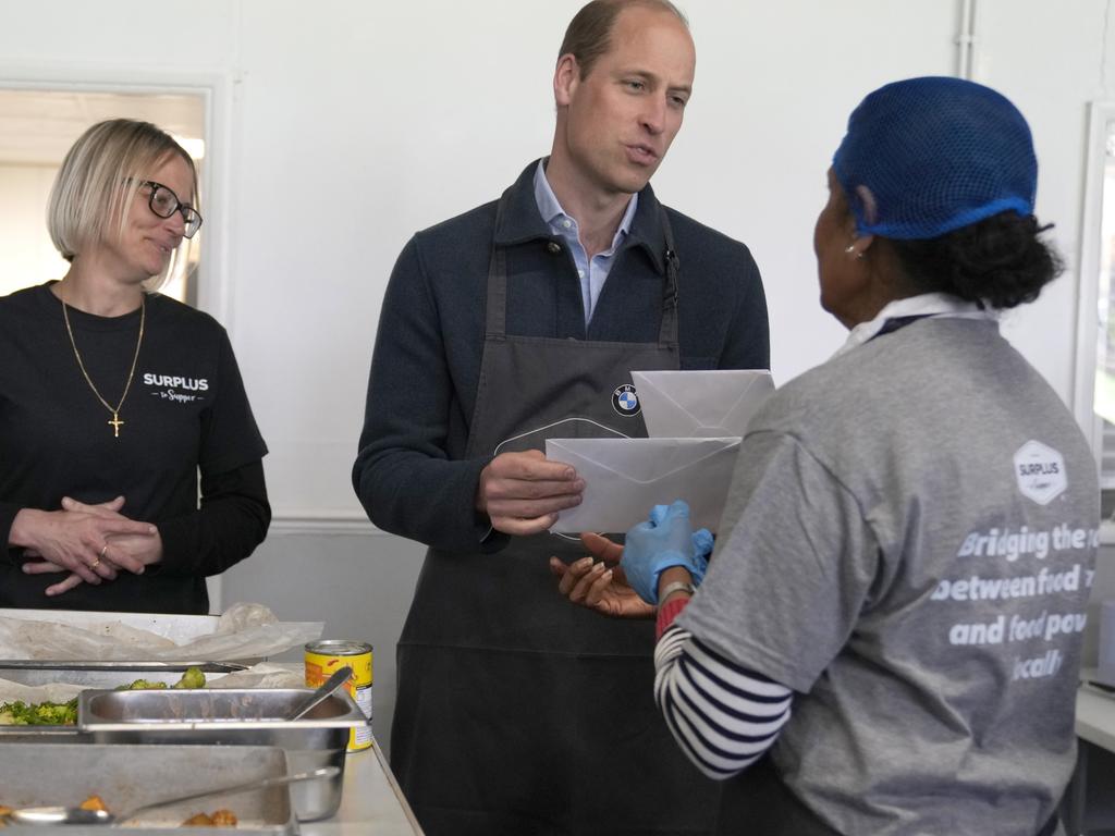 Volunteer Rachel Candappa hands get well cards for Princess Catherine to a visibly moved Prince William. Picture: Getty Images