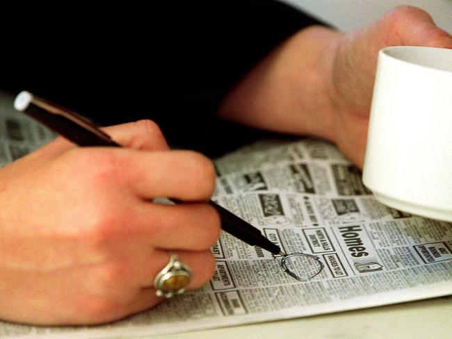 Generic photo featuring Renee Nowytarger scanning the Tele classifieds section of a newspaper with pen in her hand. People. Situation. Job advertisement. Ad. Job ads. Employment. Job hunting.