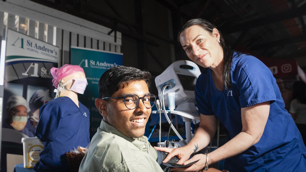 Job seeker Adhith Sivaharen with a blood pressure cuff demonstrated by St Andrew's Hospital assistant in nursing Linda Von Nida at the Toowoomba Jobs, Careers and Skills Expo. Picture: Kevin Farmer