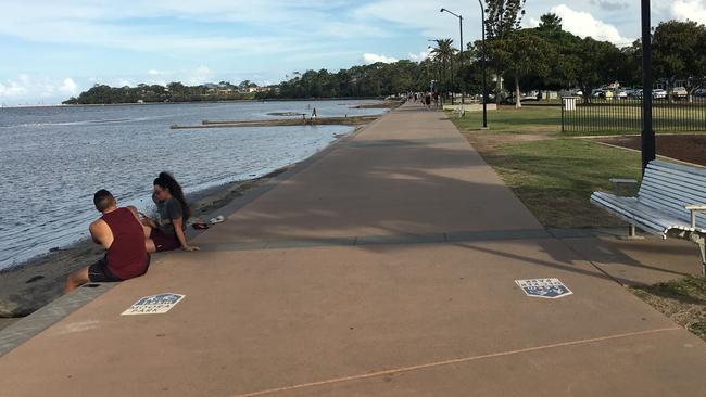 People sitting along the Sandgate-Brighton foreshore about 4pm on Thursday, April 2, 2020.