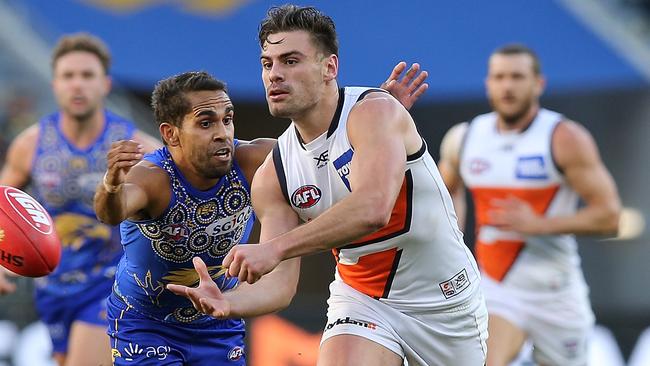 Stephen Coniglio gets a handball away.