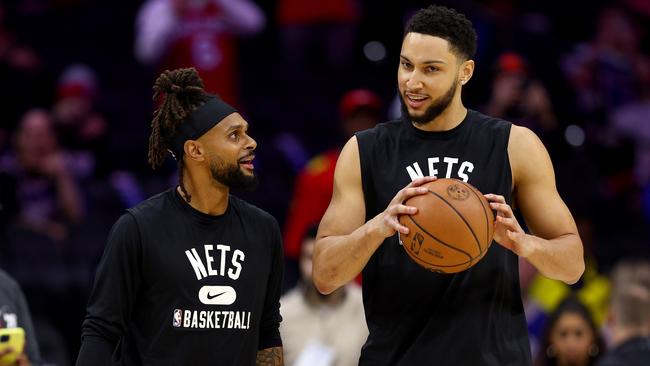 PHILADELPHIA, PENNSYLVANIA - MARCH 10:  Patty Mills #8 and Ben Simmons #10 of the Brooklyn Nets take the court for warm ups before the game against the Philadelphia 76ers at Wells Fargo Center on March 10, 2022 in Philadelphia, Pennsylvania. NOTE TO USER: User expressly acknowledges and agrees that, by downloading and or using this photograph, User is consenting to the terms and conditions of the Getty Images License Agreement. (Photo by Elsa/Getty Images)