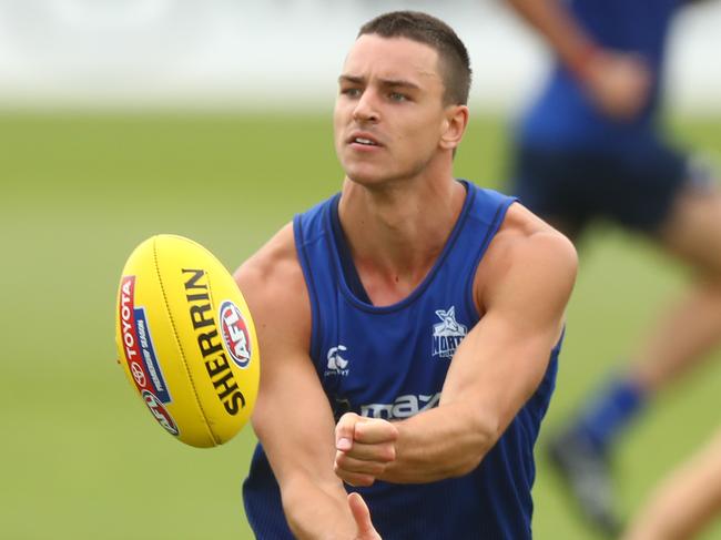 MELBOURNE, AUSTRALIA - JANUARY 18: Luke Davies-Uniacke of the Kangaroos handballs during a North Melbourne Kangaroos AFL training session at Arden Street Ground on January 18, 2021 in Melbourne, Australia. (Photo by Mike Owen/Getty Images)