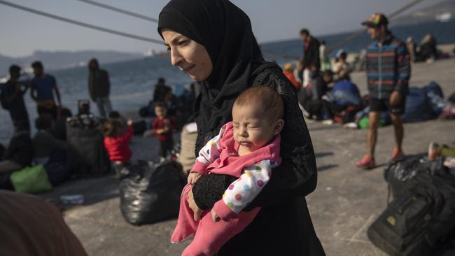 16-year-old Montaha from Aleppo, Syria, with her baby daughter Batour after their arrival at the port of Elefsina, near Athens. Picture: AP.