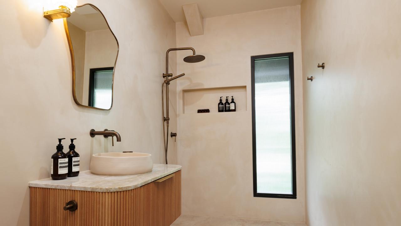 The bathrooms have a modern lux feel full of texture and raw materials. Picture: Supplied