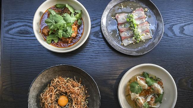 Clockwise from top left: Lamb curry, kingfish sashimi, Tom yum dumplings and black garlic mie goreng. Picture: Monique Harmer