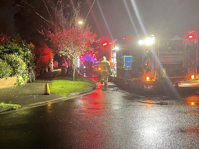 Police closed off Longfield St in Richmond on Sunday night while emergency services investigate a house fire. Picture Jack Colantuono