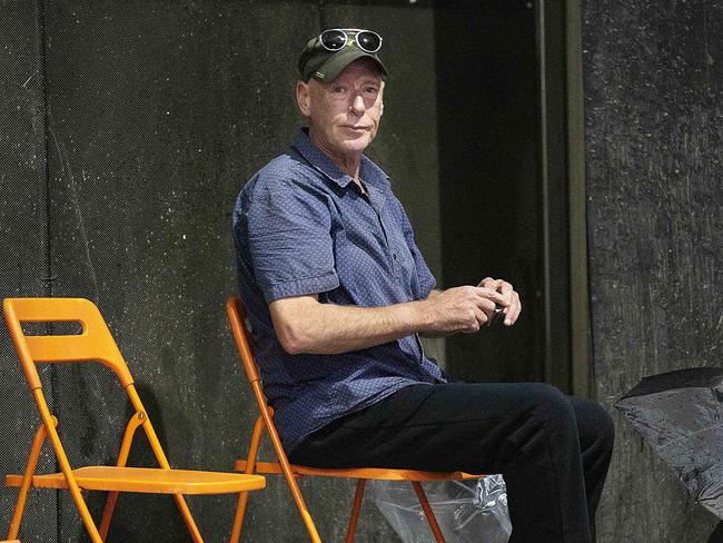 Policeman Christopher Kerley leaving Melbourne Magistrates court after getting bail.Kerley is up on charges of threats to kill , unlawful assault.Kerley discreetly gathers his possessions up a laneway after getting parole. Reporter Dave Hurley to identify. Picture : Ian Currie