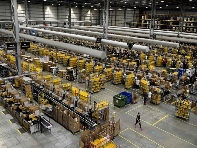 (FILES) In this file photo taken on November 27, 2019 Amazon workers sort and pack items at the Amazon Fulfilment Centre in Peterborough, east England on November 27, 2019, as preparations are underway for the annual Black Friday Sale. - Amazon will create 7,000 permanent jobs in the UK by the end of the year, the American e-commerce giant announced on September 3, 2020 in a boost for Britain's virus-hit economy. (Photo by DANIEL LEAL-OLIVAS / AFP)