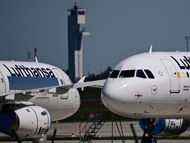 (FILES) Parked aircrafts operated by German airline Lufthansa are pictured at Berlin Brandenburg BER airport Willy-Brandt in Schoenefeld near Berlin on May 31, 2021. German airline Lufthansa on April 11, 2024 said it would continue to suspend flights to and from Tehran until April 13 due to tensions in the Middle East. "Due to the current situation, Lufthansa is suspending its flights to and from Tehran up to and including Saturday, 13 April, after careful evaluation," the airline said in a statement. (Photo by Tobias Schwarz / AFP)