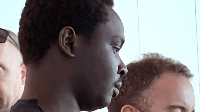 MELBOURNE AUSTRALIA - Newswire Photos JANUARY 15TH 2023 : Accused murderer Koang Wuordol, arrested over the murder of Sudanese teenager Yiel Gatluak, boards a Qantas flight at Melbourne Airport, and is extradited to Alice Springs. PICTURE : NCA Newswire / Nicki Connolly