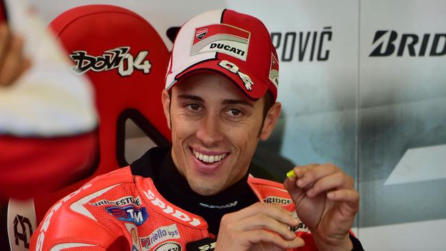 Italy's Andrea Dovizioso of Ducati Team sits in the pit area during the free practice session ahead of the San Marino Moto Grand Prix at the Misano world circuit in Misano Adriatico on September 12, 2014. AFP PHOTO / GIUSEPPE CACACE