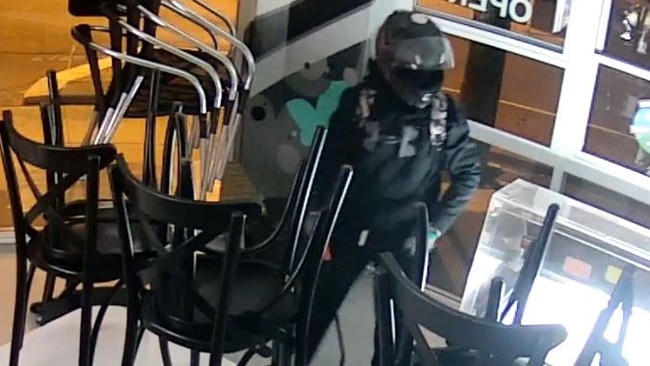 suspect wearing a bike helmet moments after breaking into Ground Control Chippery at Warners Bay at 4.53am on March 20. Picture: supplied