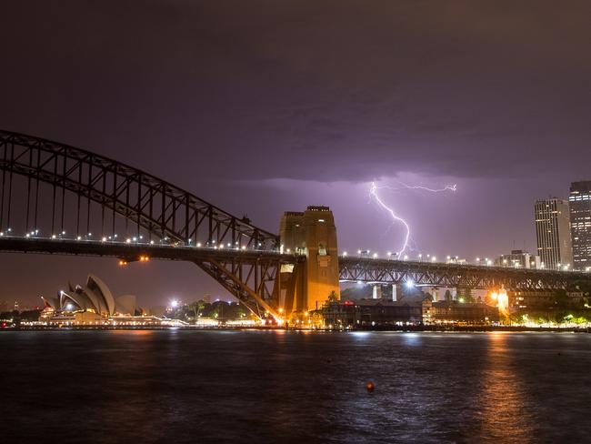 Lightning strikes over the city overnight after Sydney's record breaking heat. Picture: Steve Harris