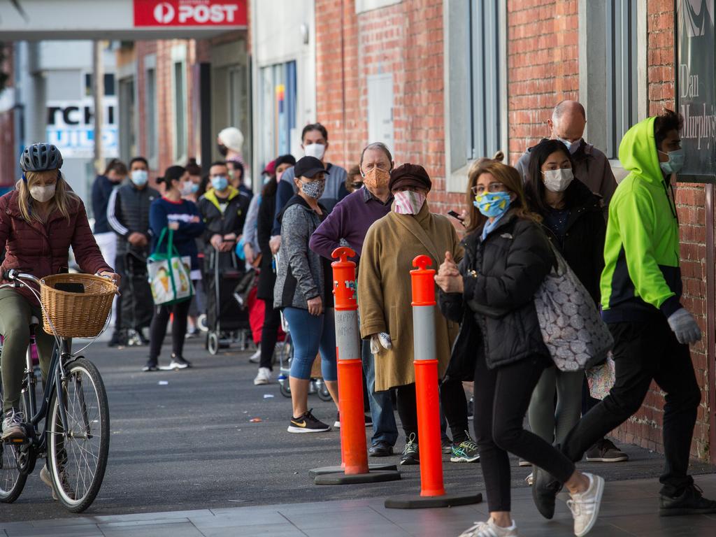 Shoppers were told not to panic-buy food on Sunday as long lines were seen at supermarkets such as Aldi at South Melbourne. Picture: Paul Jeffers