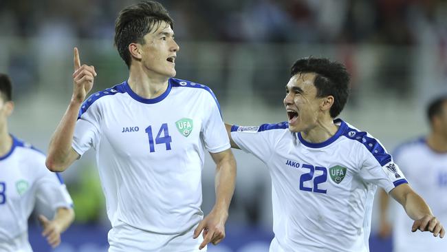 Eldor Shomurodov celebrates a goal for Uzbekistan.