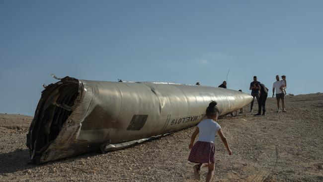 A child runs near the remains of a missile on October 2, near the Dead Sea, Israel. Iran launched a missile strike on Israel saying the attack was retaliation and citing assassinations they believe Israel carried out in Tehran and Damascus. Picture: Getty