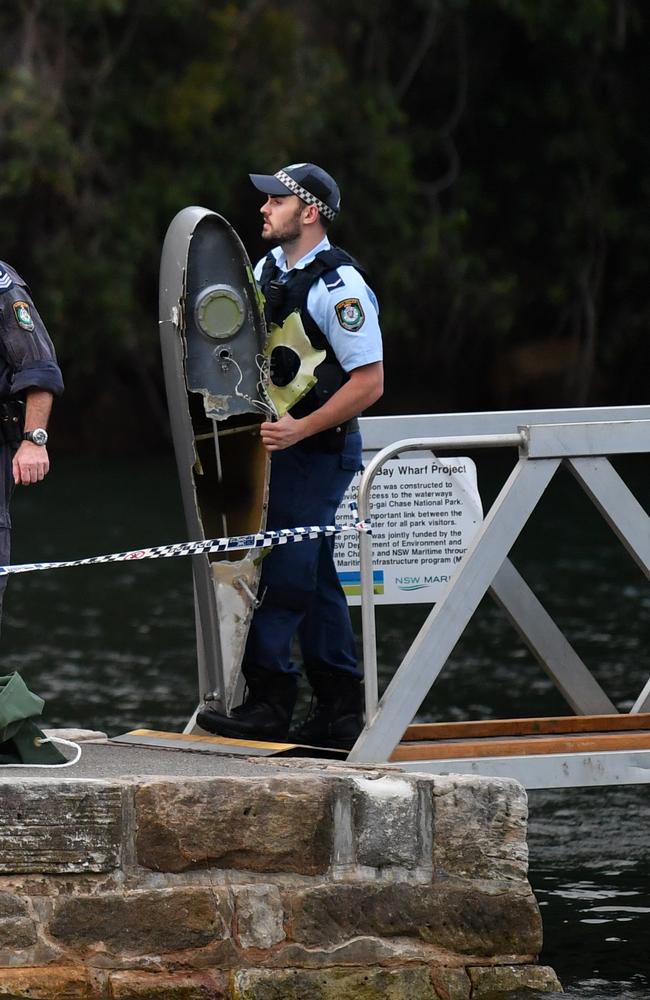 Police recover debris from the wreckage. Picture: John Grainger.