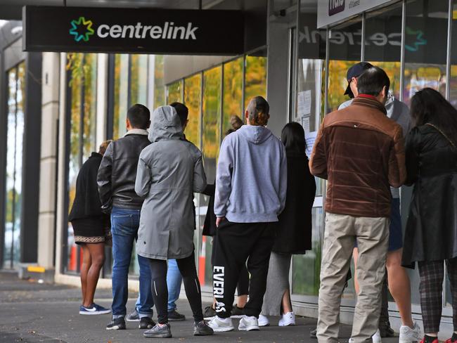 People queue up outside a Centrelink office in Melbourne.