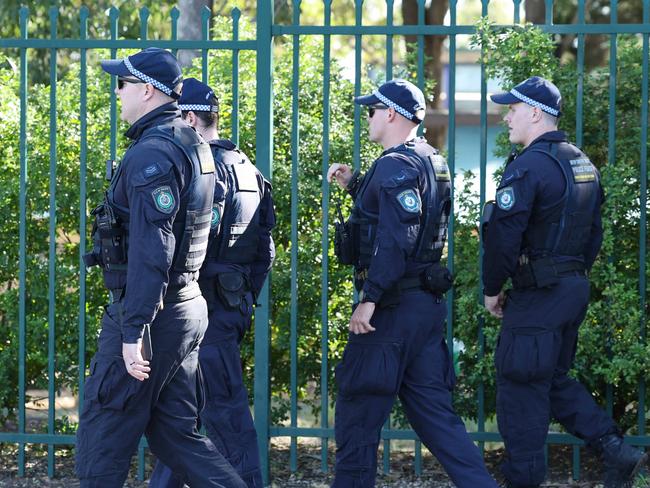 Riot Squad Police conducting a line search outside Crawford Public School in Doonside on Saturday morning. Picture: Tim Hunter