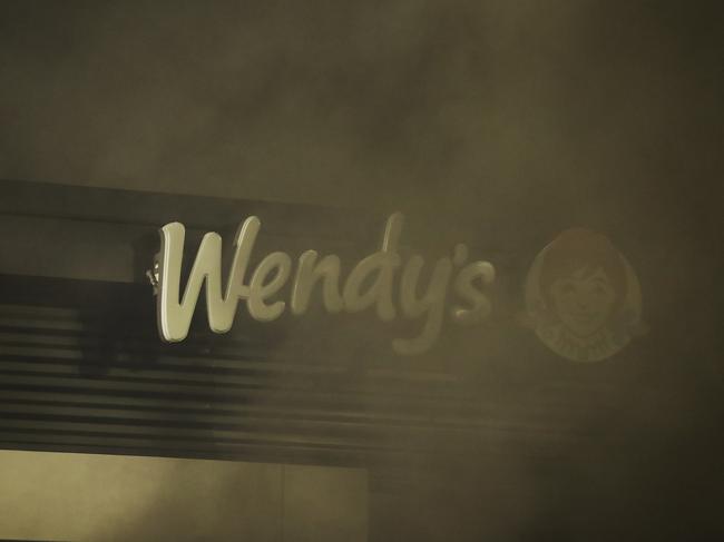 A Wendy's restaurant sign is engulfed in smoke during a protest in Atlanta. The restaurant was where Rayshard Brooks was shot and killed by police, following a struggle in the restaurant's drive-through line. Picture: AP Photo/Brynn Anderson