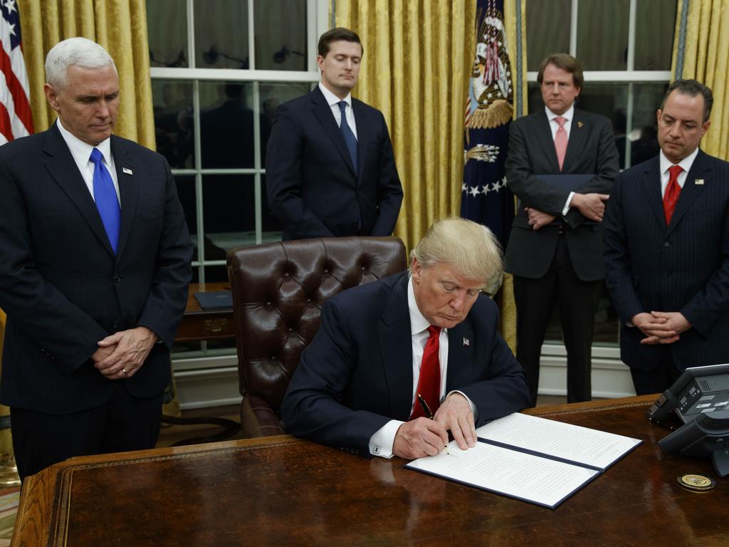 President Donald Trump signs his first executive order on January 20, 2017. More than 100 executive orders have been drawn up for the Republican to sign on the day of his second inauguration. Picture: AP Photo/Evan Vucci