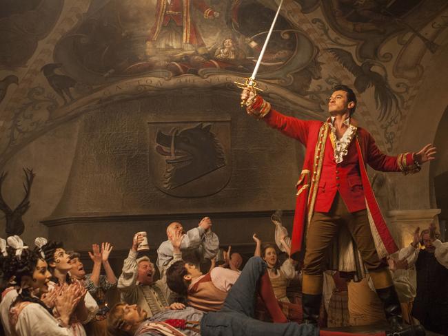 Gaston (Luke Evans) a handsome but arrogant brute, holds court in the village tavern in Disney's Beauty and the Beast.