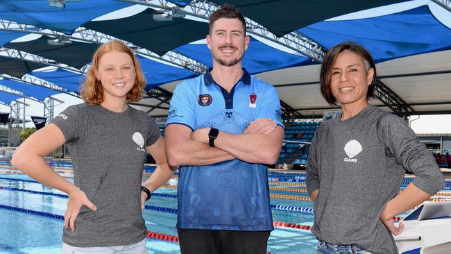 Harriet Grant and Kaname Woodfield, both Masters Swimming Queensland Champions, with Sean Hunter, AFL Cape York Girls Boarding House Manager. Picture: Isaac McCarthy.