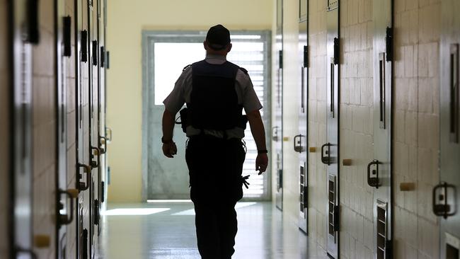 A corrections officer walks down a cell corridor at Borallon Correctional Centre, in Brisbane. (AAP Image/Jono Searle)