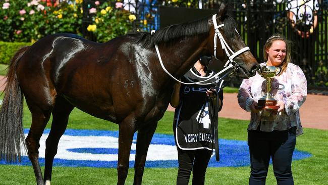 Waller’s stable representative Jo Taylor holds with Melbourne Cup trophy with Verry Elleegant. Picture: AFP