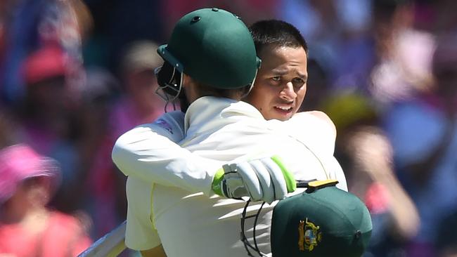 Australia's Usman Khawaja embraces Steve Smith after his ton.