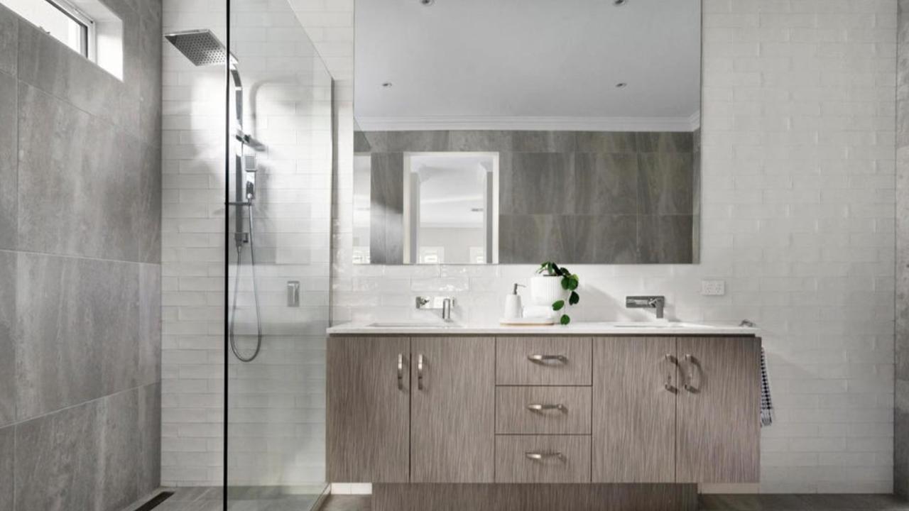 One of the home’s massive bathroom features a high-end stone finishes and a freestanding tub.