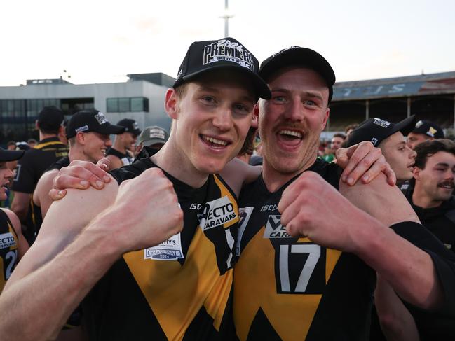 Johnson celebrates Werribee’s VFL premiership win with Hudson Garoni.