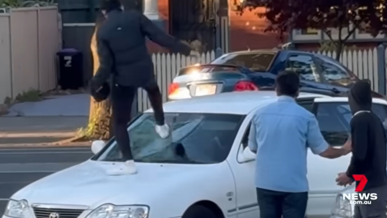 Vision of the incident shows a young man jumping onto the hood of the buyer's car and stomping on the windshield. Picture: 7 News